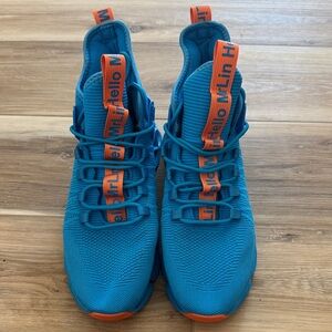 Dynamic Blue Sneakers with Orange Highlights